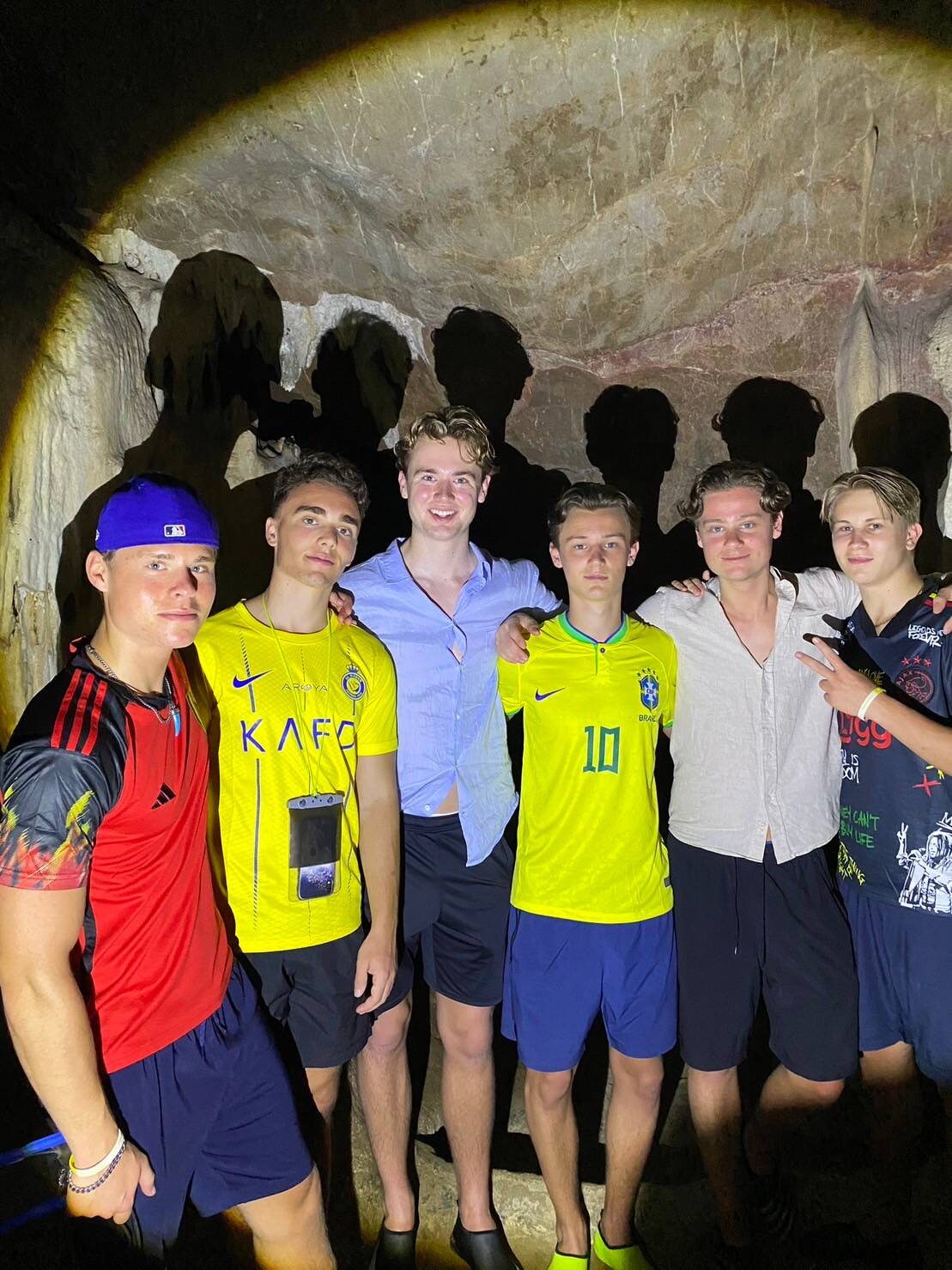 A group of guests posing inside a Phang Nga Bay sea cave