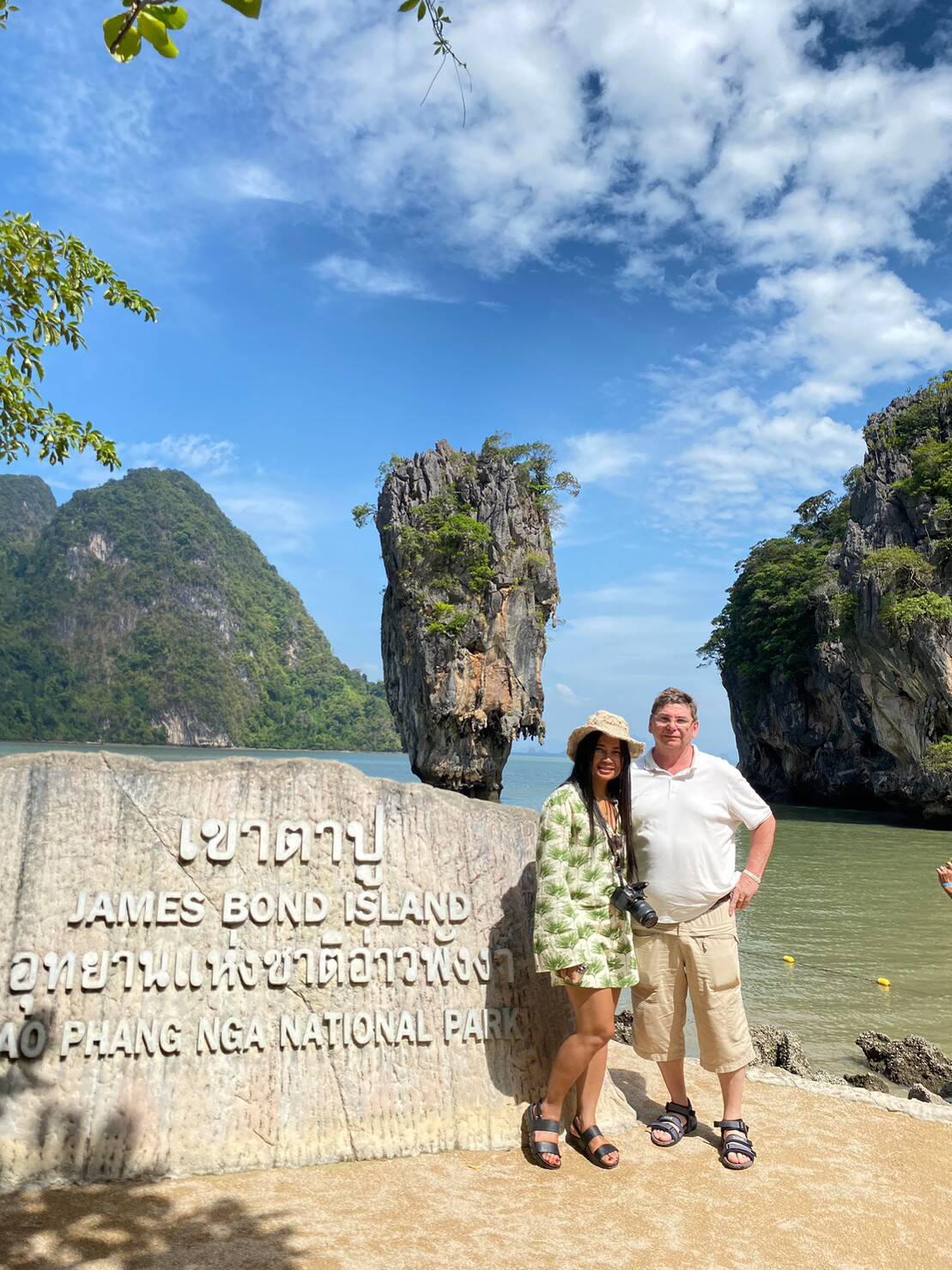 Guests posing beside the James Bond Island rock formation, Ko Tapu
