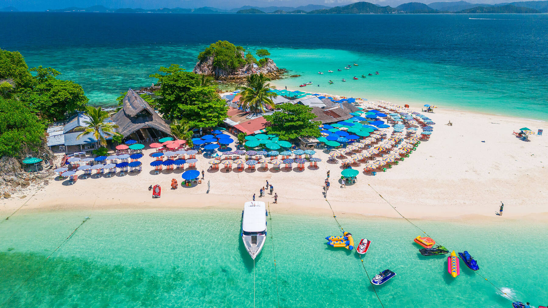 Aerial view of a Khai Island beach with umbrellas, sun loungers and jet skis