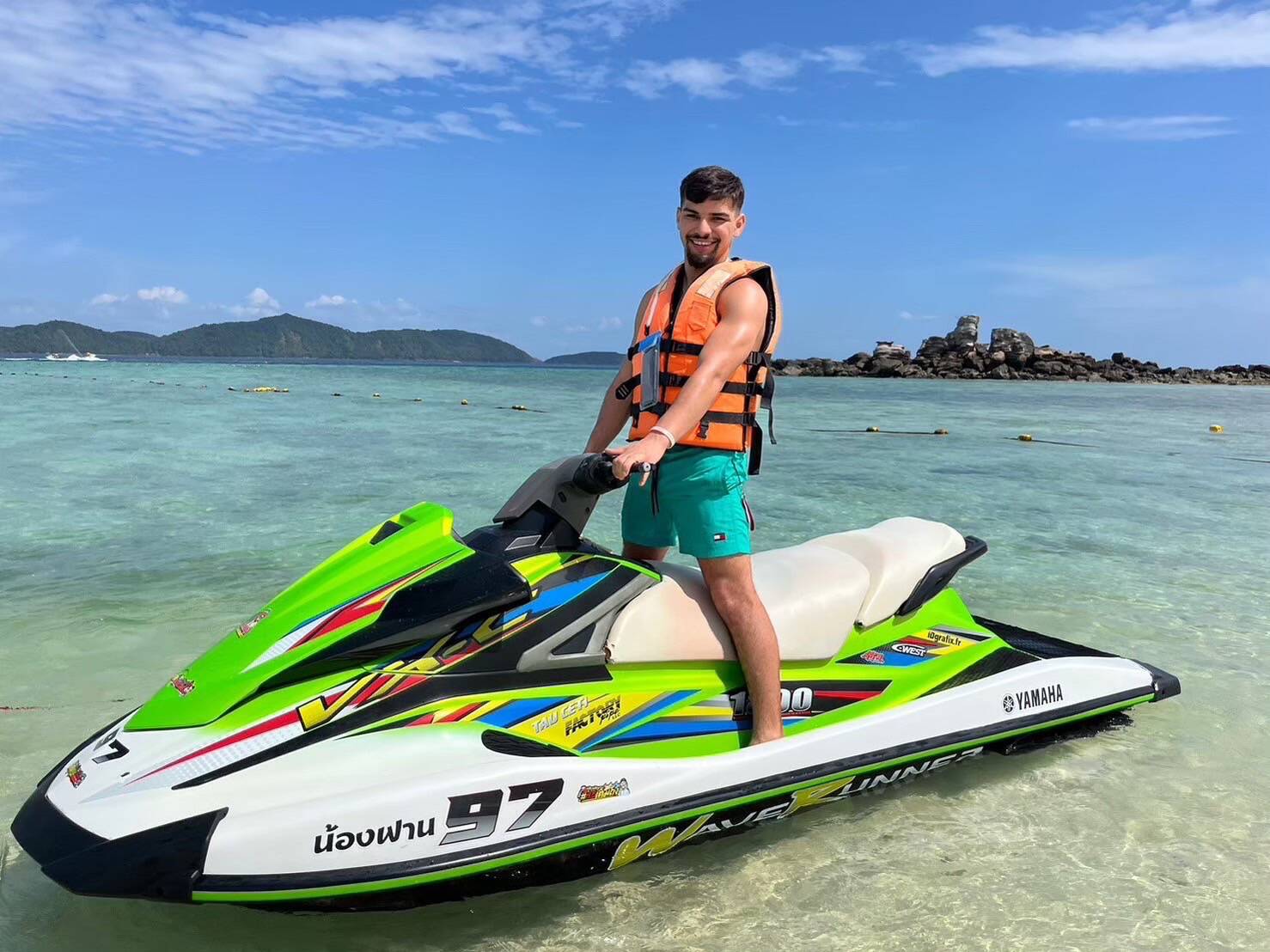 A guest riding a jet ski in the shallow water at Khai Island