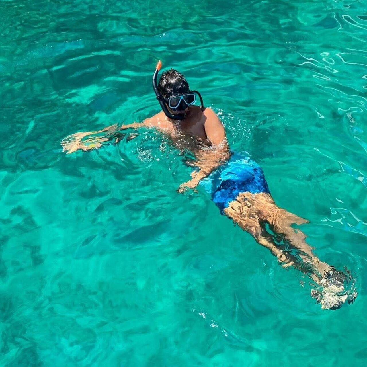 A guest snorkeling in the clear water at Phi Phi