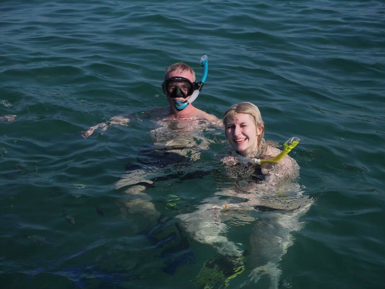 Two guests snorkeling together at Racha Island