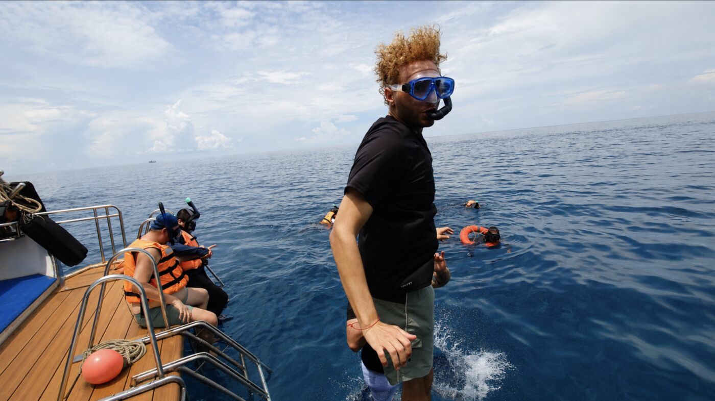 Guest jumping into the water on the Racha Island snorkeling and yacht tour