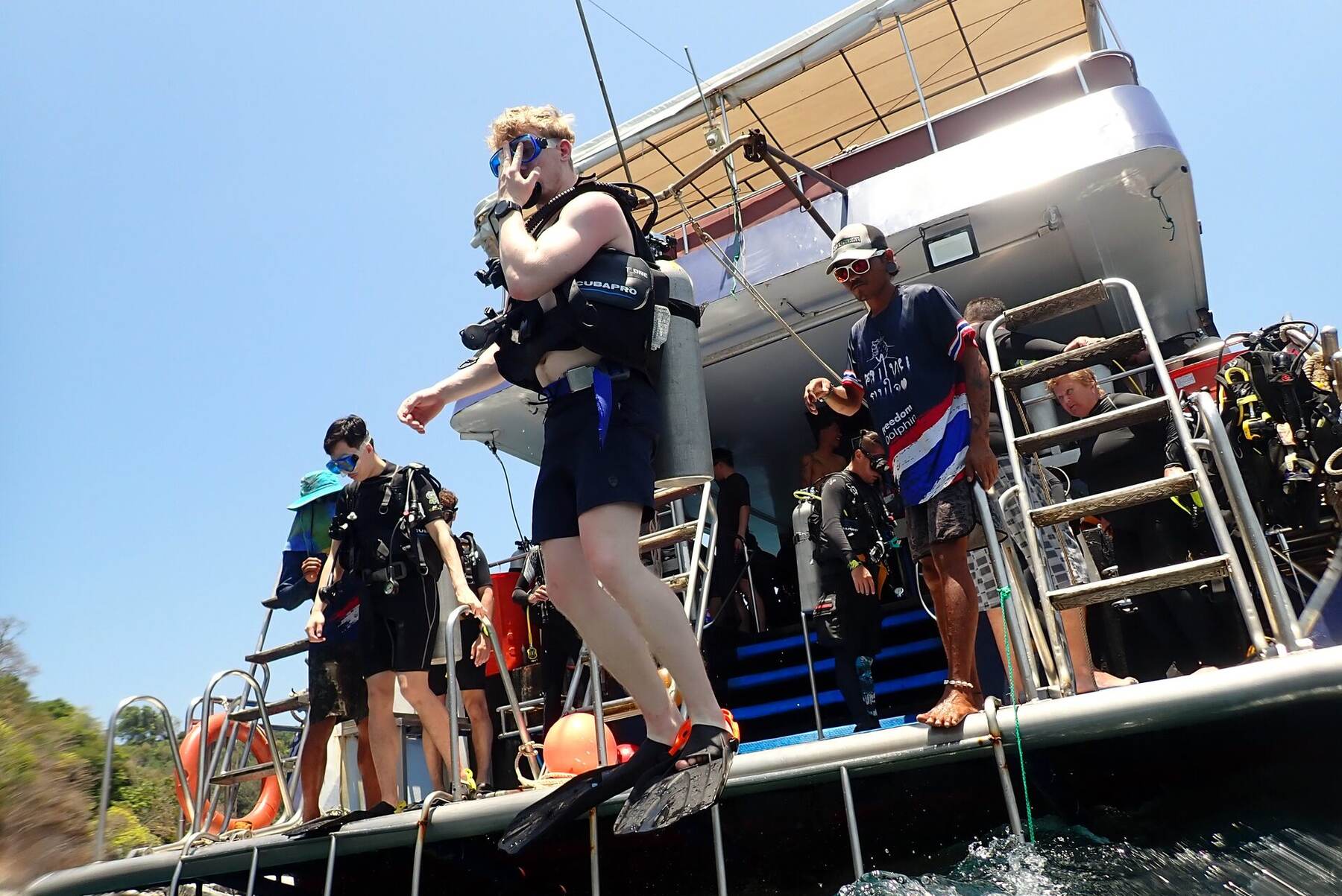 Divers stepping off the boat at the start of a Racha Island dive